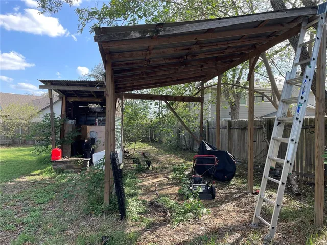 a view of a porch with furniture and a yard