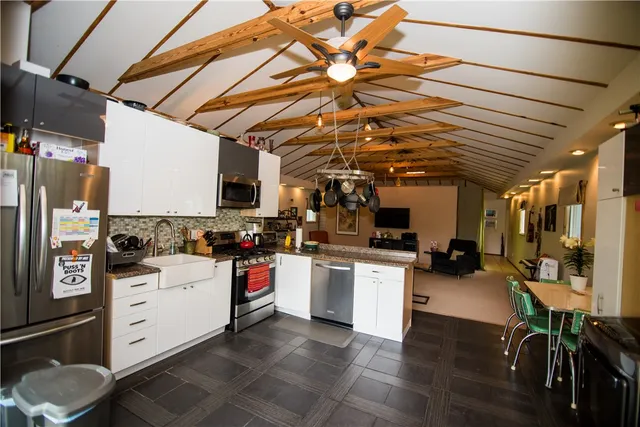 a kitchen with a sink a stove and cabinets