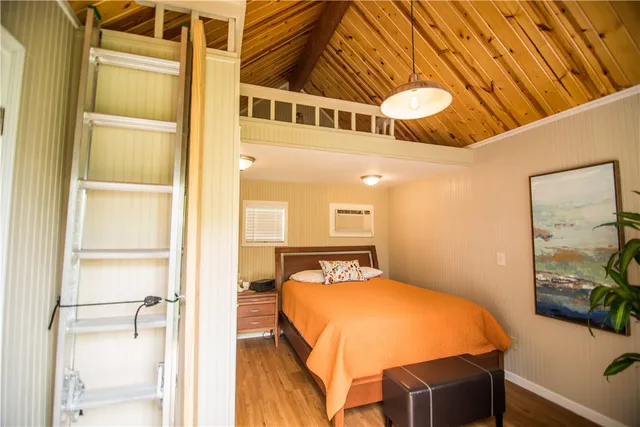 a bedroom with a bed and a table with painted walls