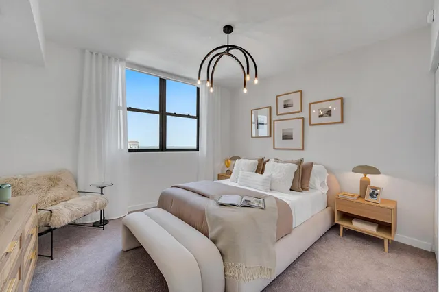 a bedroom with a bed and a window