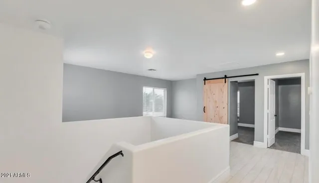 a view of a hallway to rooms