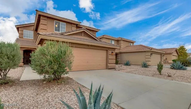 a view of a house with a yard and garage