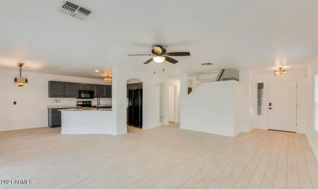 a view of a kitchen with a sink and a refrigerator