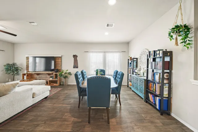 a living room with furniture a bookshelf and a book shelf