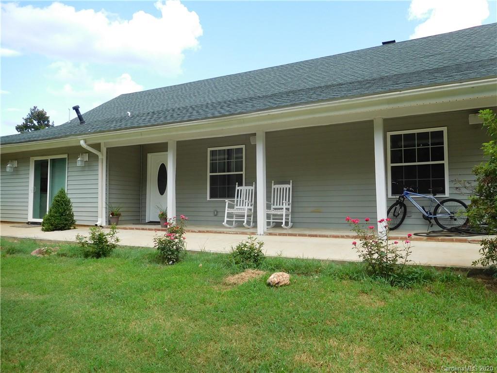 a front view of a house with a yard and outdoor seating