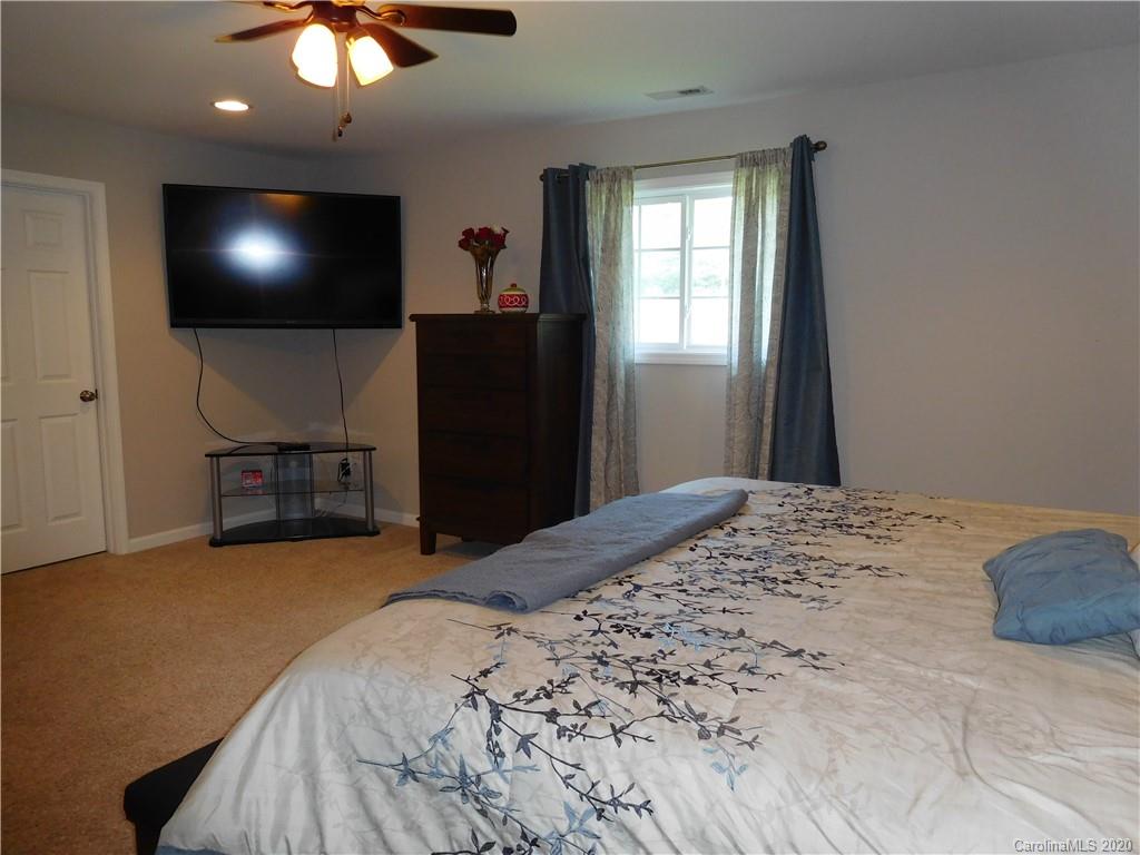 161 Cook Sears Road Gastonia, NC 28056 - Photo 13 of 31 a bedroom with a bed and a flat screen tv