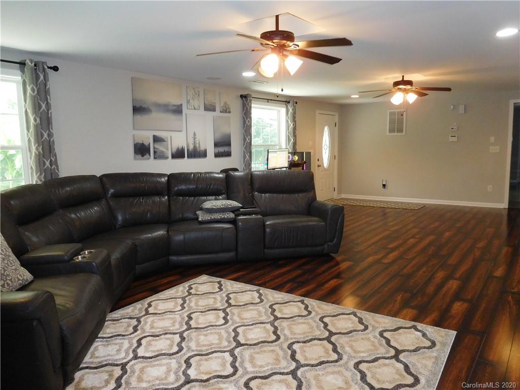 161 Cook Sears Road Gastonia, NC 28056 - Photo 3 of 31 a living room with furniture and a chandelier