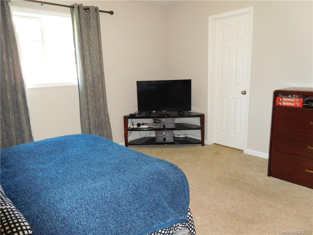 161 Cook Sears Road Gastonia, NC 28056 - Photo 21 of 31 a bedroom with furniture and flat screen tv