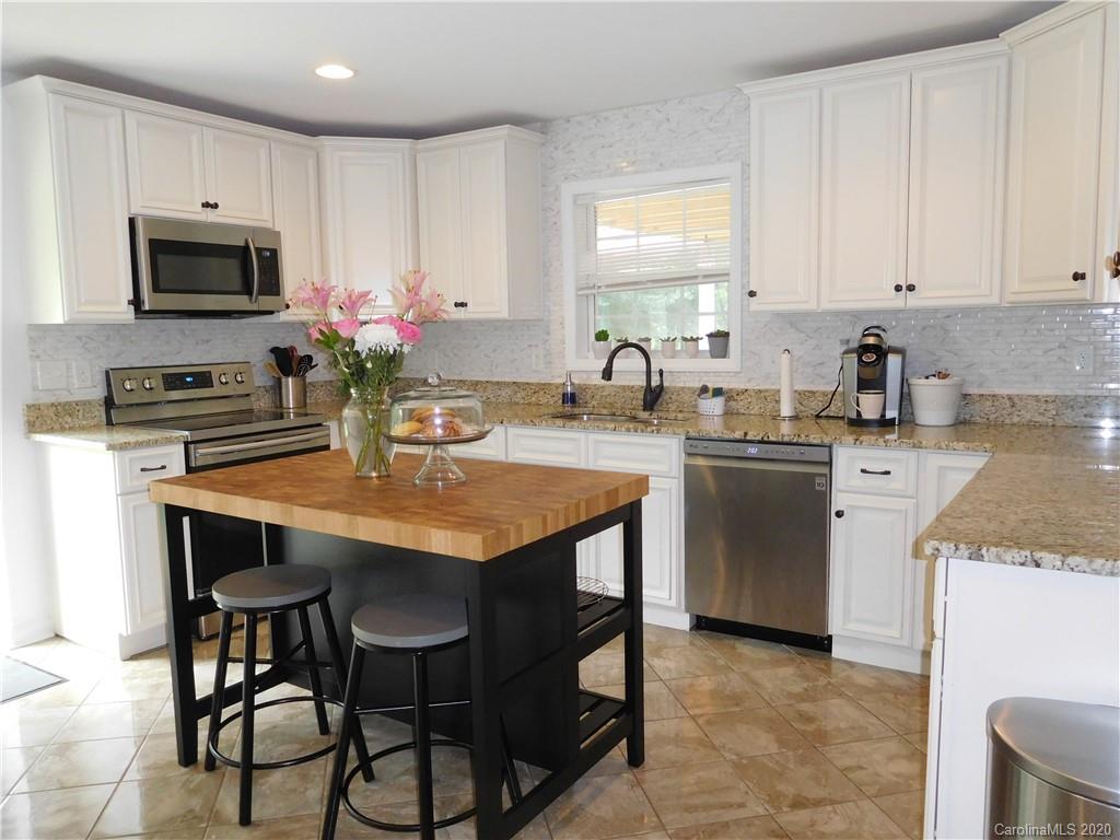 161 Cook Sears Road Gastonia, NC 28056 - Photo 9 of 31 a kitchen with granite countertop a sink stove and white cabinets