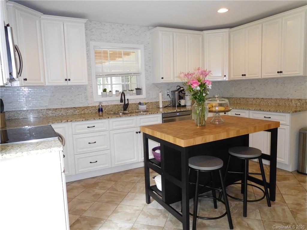 161 Cook Sears Road Gastonia, NC 28056 - Photo 10 of 31 a kitchen with granite countertop a table chairs sink and cabinets
