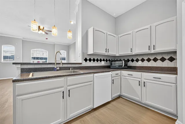 a kitchen with white cabinets and white appliances