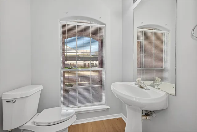 a view of a hallway with wooden floor and entryway
