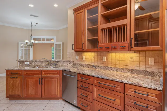 a kitchen with granite countertop a sink and cabinets