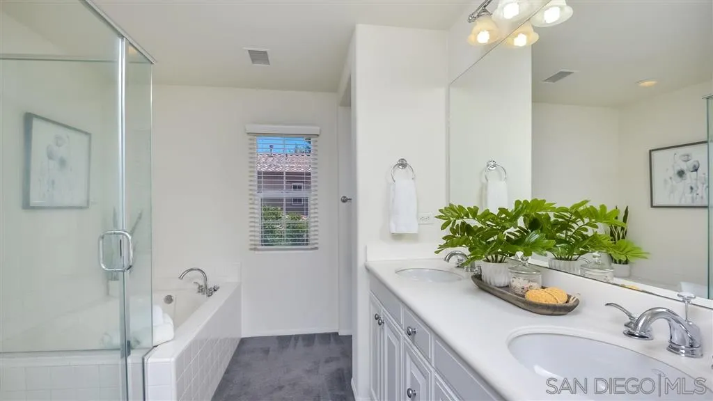 12 Night Bloom Irvine, CA 92602 - Photo 12 of 25 a bathroom with a granite countertop sink a vanity and a mirror