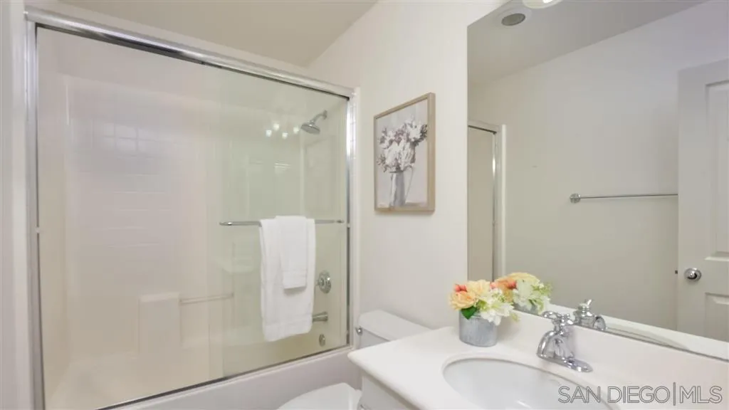 12 Night Bloom Irvine, CA 92602 - Photo 15 of 25 a bathroom with a granite countertop shower sink and mirror