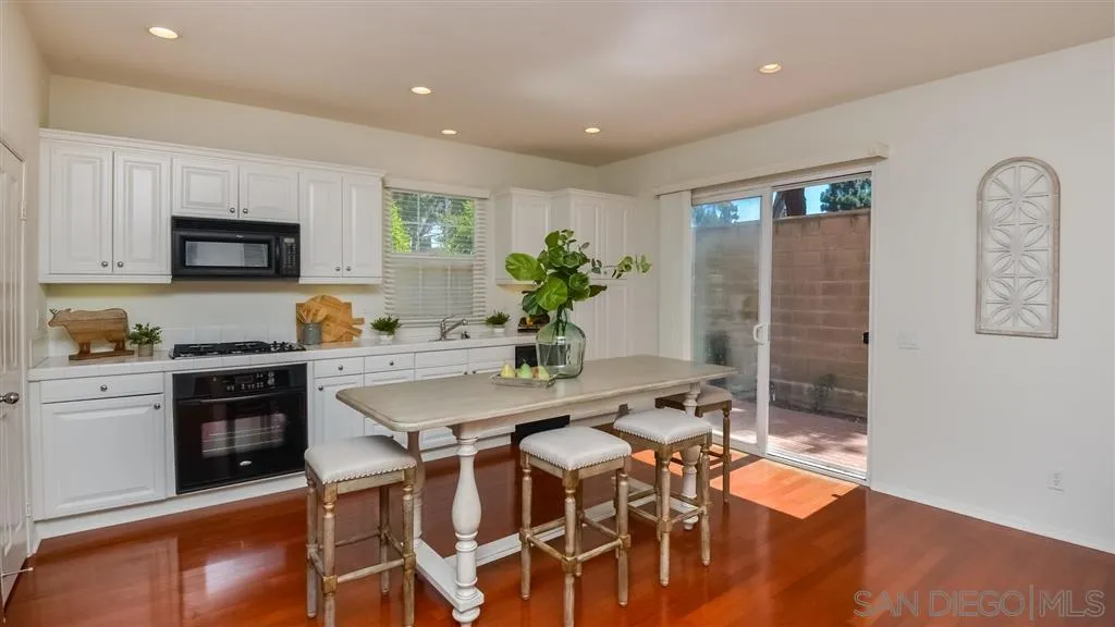 12 Night Bloom Irvine, CA 92602 - Photo 2 of 25 a kitchen with stainless steel appliances a dining table chairs and granite counter tops