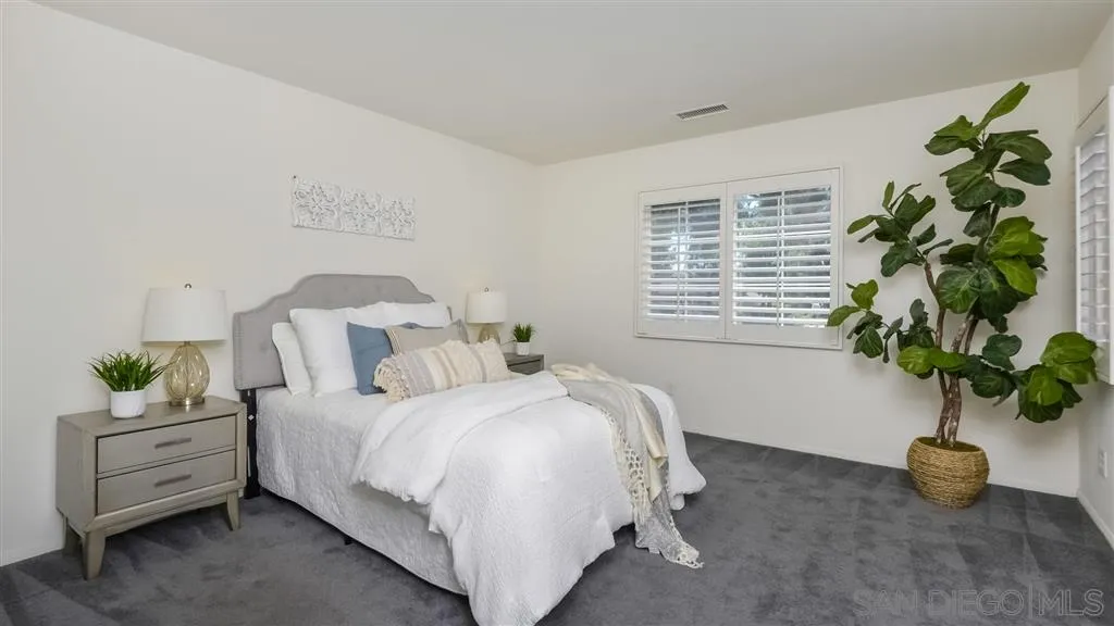 12 Night Bloom Irvine, CA 92602 - Photo 9 of 25 a bedroom with a bed a couch and a potted plant