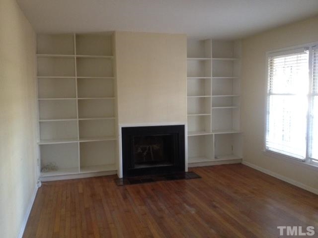 5001 Auburn Road Raleigh, NC 27609 - Photo 3 of 20 an empty room with a fireplace and a window