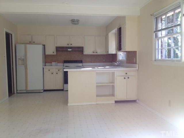 5001 Auburn Road Raleigh, NC 27609 - Photo 4 of 20 a kitchen with a stove a refrigerator and a sink