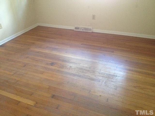 5001 Auburn Road Raleigh, NC 27609 - Photo 7 of 20 en empty room with wooden floor