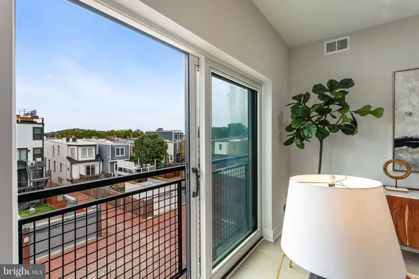 a view of a balcony with chair and wooden floor