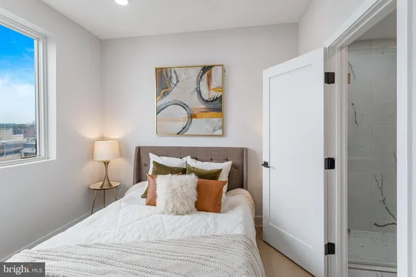 a bedroom with a bed and a couch