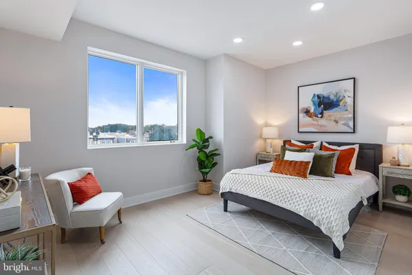 a bedroom with a bed potted plant and a window