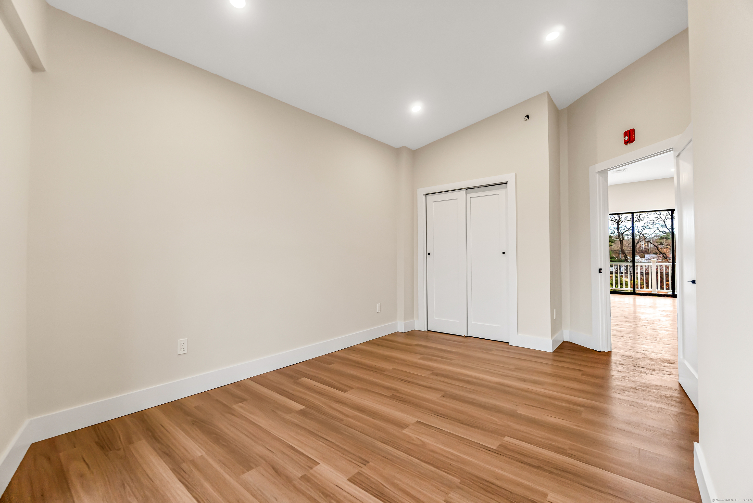 937 Post Road, Unit 3A Fairfield, CT 06824 - Photo 12 of 24 a view of empty room with wooden floor