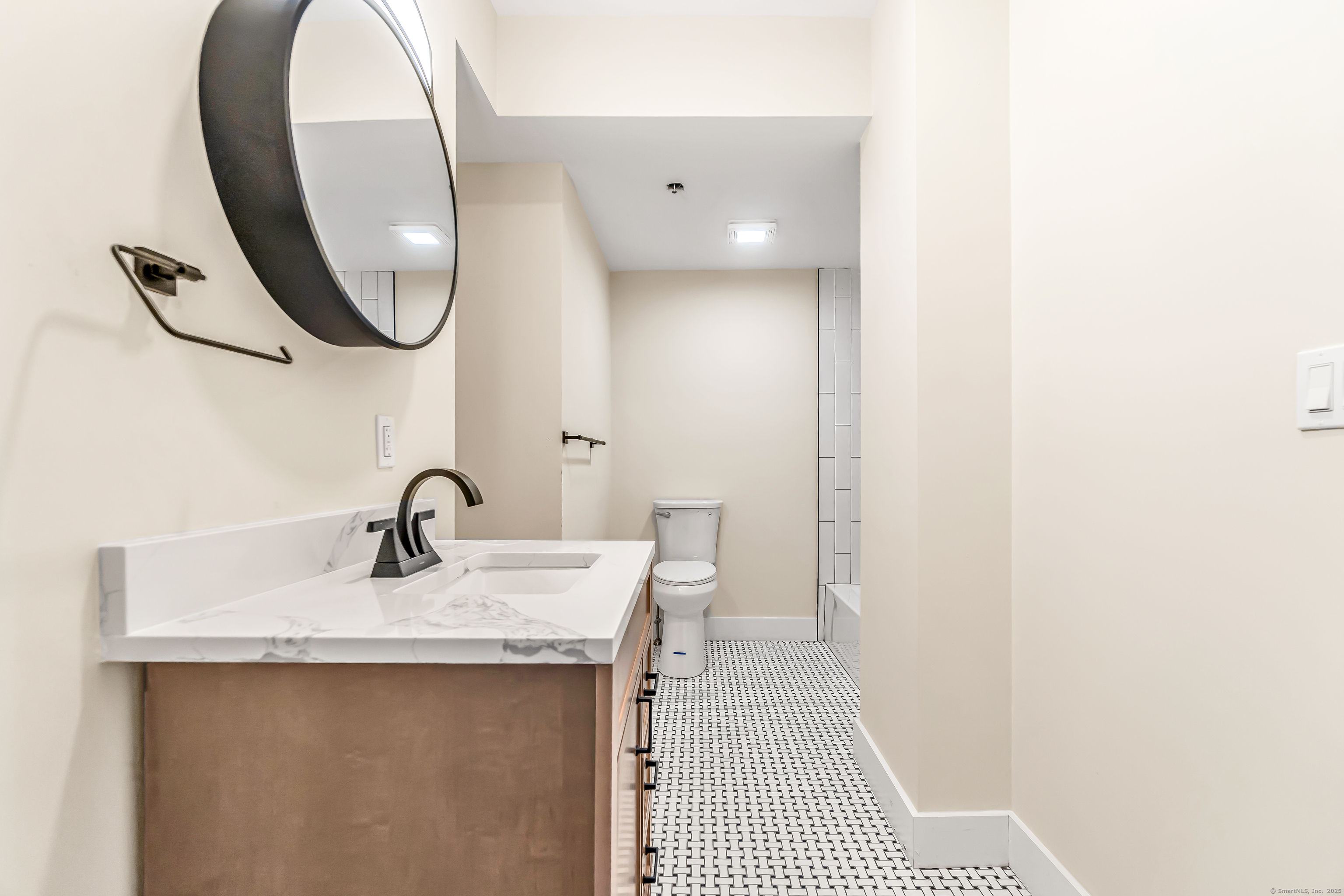 937 Post Road, Unit 3A Fairfield, CT 06824 - Photo 19 of 24 a bathroom with a sink and a mirror