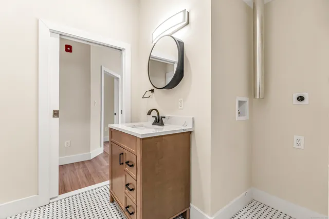 a bathroom with a sink a mirror and a shower