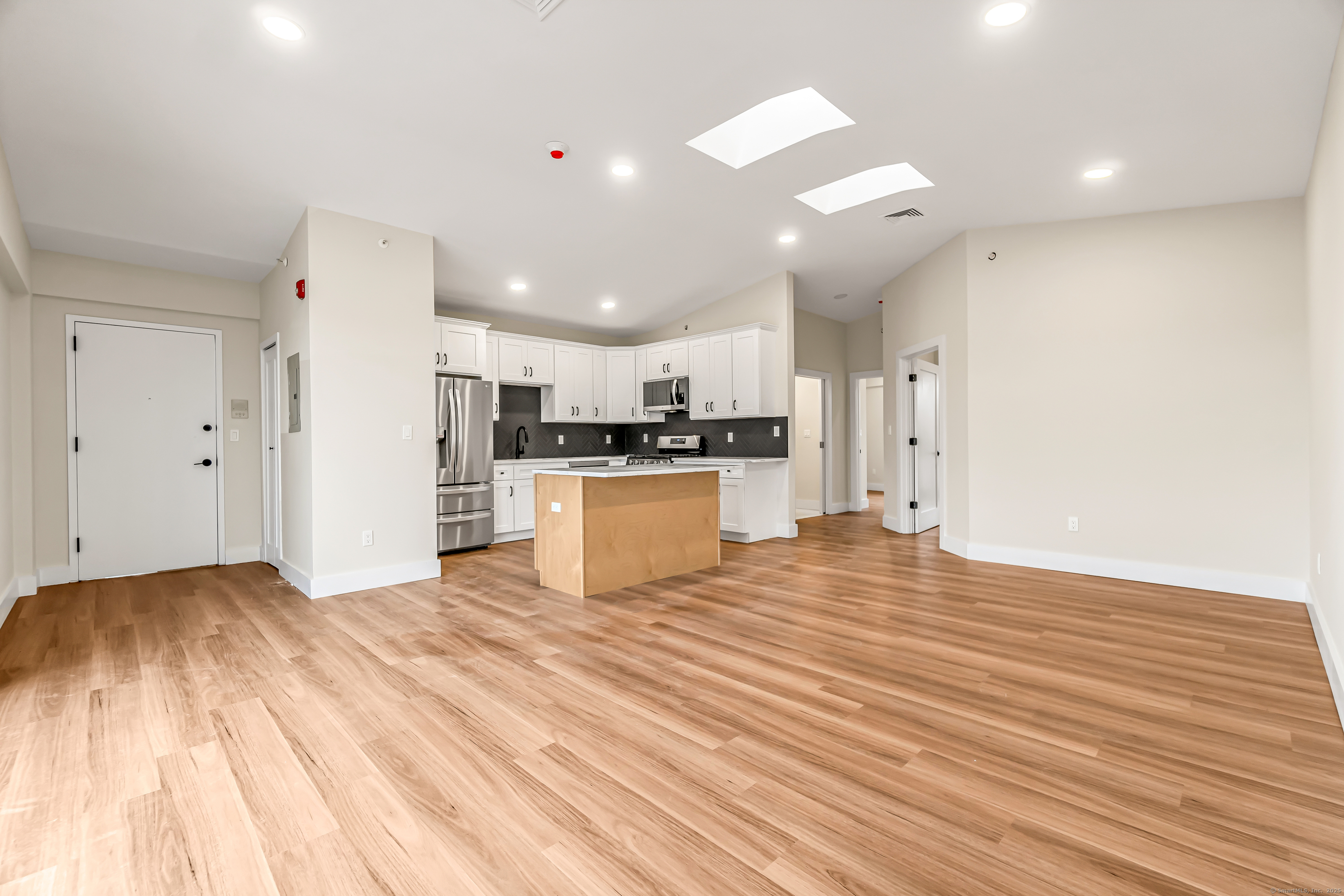 937 Post Road, Unit 3A Fairfield, CT 06824 - Photo 3 of 24 a view of kitchen with wooden floor