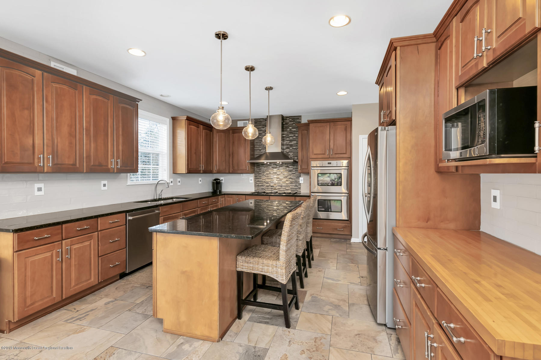 1614 Barkalow Road Wall, NJ 07719 - Photo 11 of 41 a kitchen with kitchen island granite countertop wooden cabinets stainless steel appliances a sink and a center island