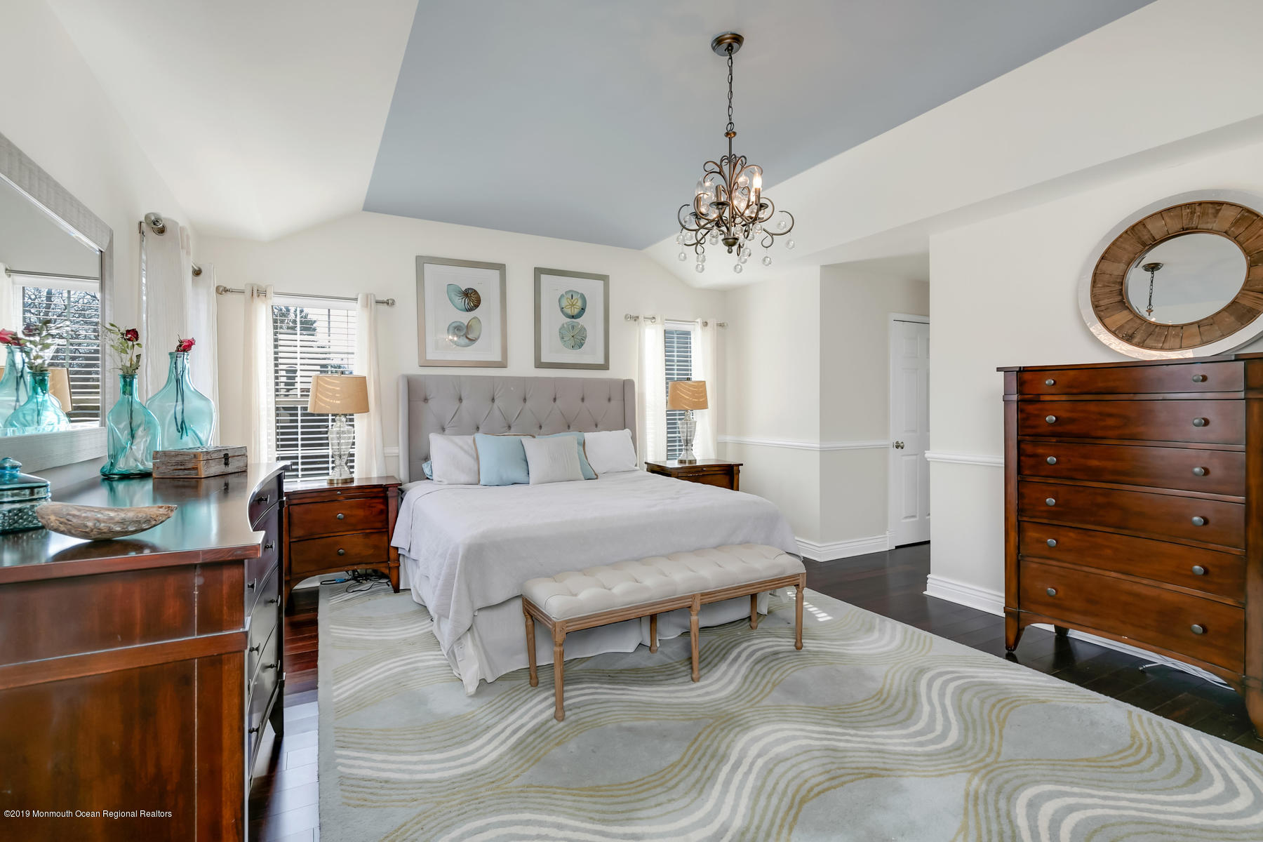 1614 Barkalow Road Wall, NJ 07719 - Photo 17 of 41 a bedroom with a bed chandelier and a mirror