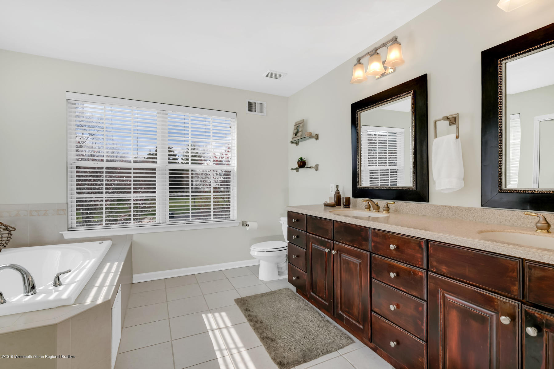 1614 Barkalow Road Wall, NJ 07719 - Photo 18 of 41 a spacious bathroom with a granite countertop tub sink and mirror