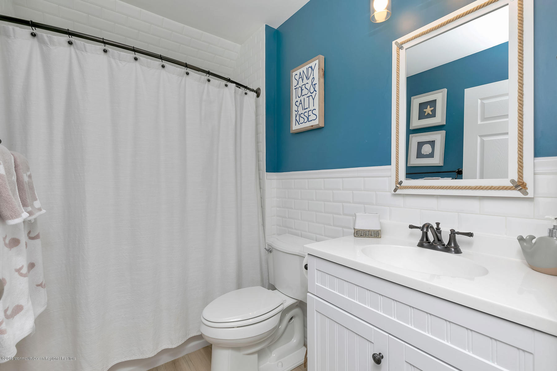 1614 Barkalow Road Wall, NJ 07719 - Photo 21 of 41 a bathroom with a sink a toilet and a mirror