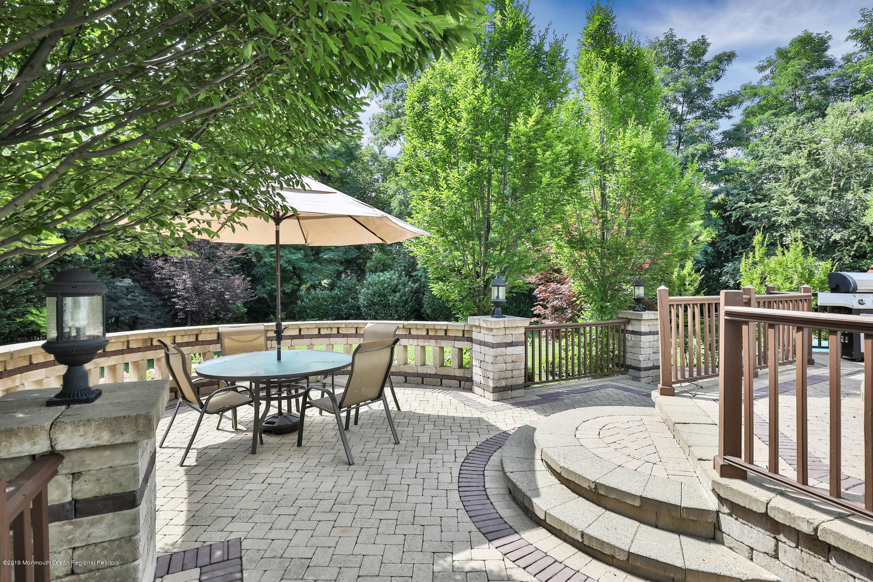1614 Barkalow Road Wall, NJ 07719 - Photo 38 of 41 a view of a patio with a dining table and chairs