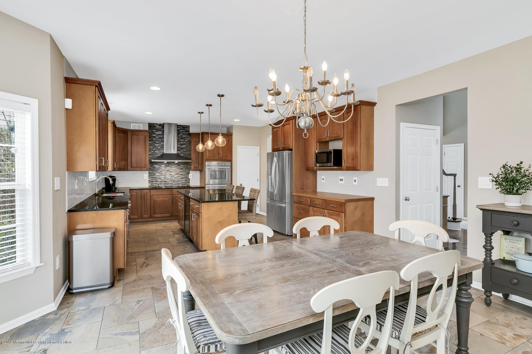 1614 Barkalow Road Wall, NJ 07719 - Photo 9 of 41 a view of a dining room and livingroom with furniture a chandelier and kitchen view