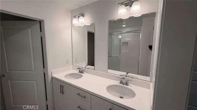 a bathroom with a sink double vanity and a mirror