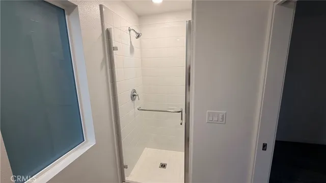 a bathroom with a glass shower door