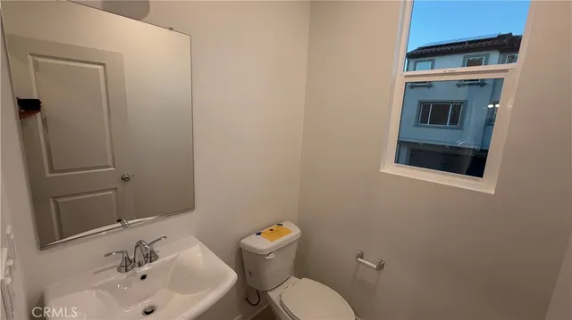 a bathroom with a sink mirror and toilet