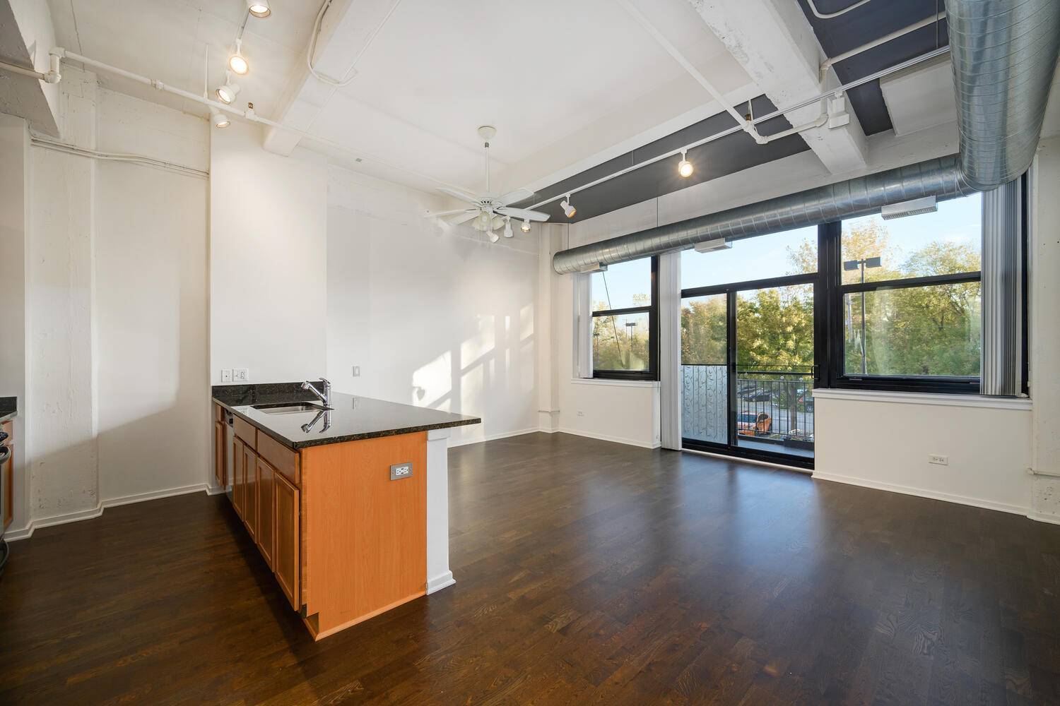 2323 West Pershing Road, Unit 222 Chicago, IL 60609 - Photo 4 of 22 a kitchen with stainless steel appliances granite countertop a stove and a large window