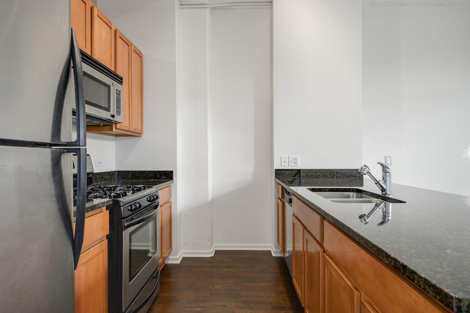 2323 West Pershing Road, Unit 222 Chicago, IL 60609 - Photo 9 of 22 a kitchen with granite countertop cabinets stainless steel appliances and a sink