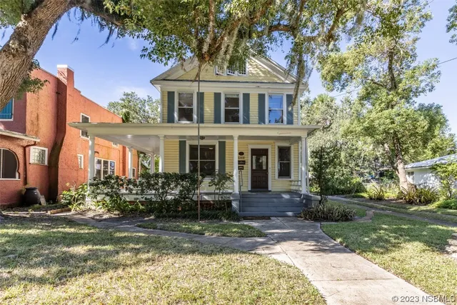 a front view of house with yard and green space