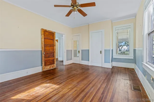 wooden floor in an empty room with a window
