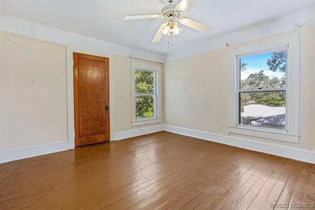 wooden floor in an empty room with a window