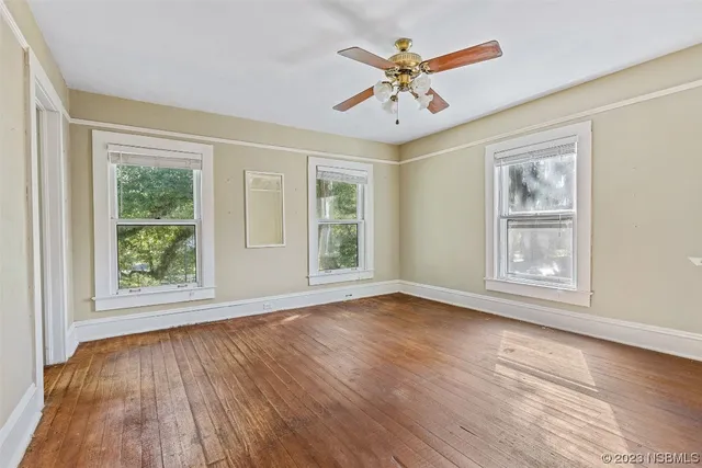 wooden floor in an empty room with a window