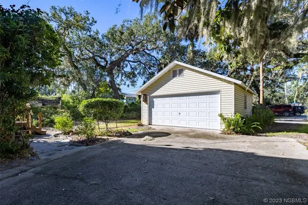 a view of backyard of house with green space