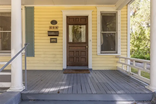 a view of front door of house with wooden floor