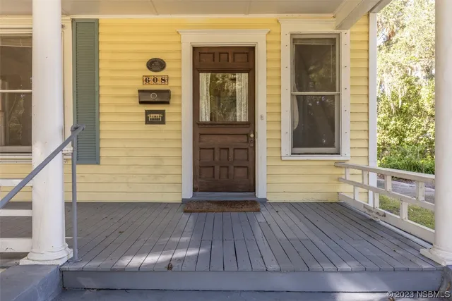 a view of front door of house with wooden floor