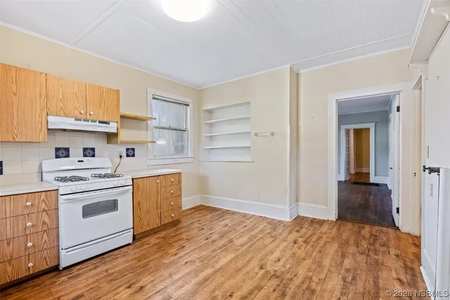 a kitchen with a stove oven and sink